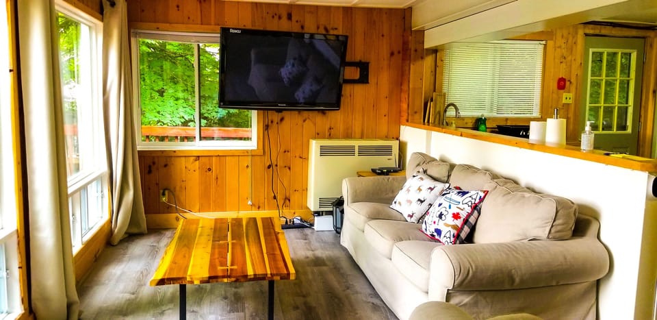 The living room features cozy sofas and Netflix TV