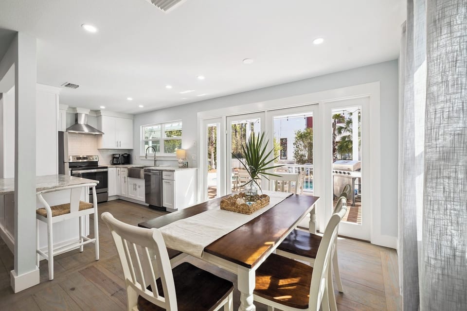 You'll love gathering around this bright dining table, with your modern kitchen nearby and patio doors opening to outdoor relaxation.