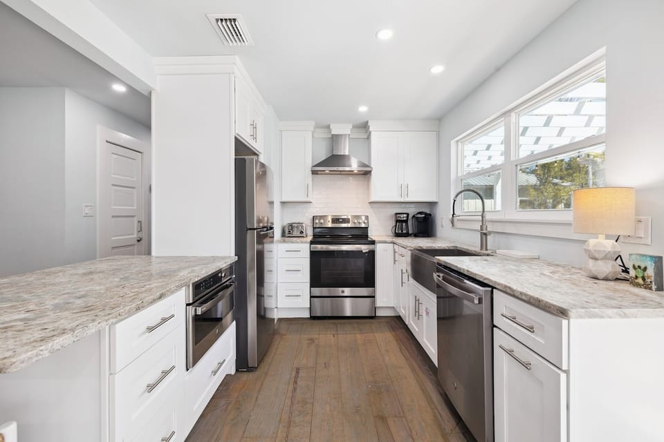 Your gourmet kitchen awaits with gleaming countertops, stainless appliances, and everything needed to create memorable meals together.