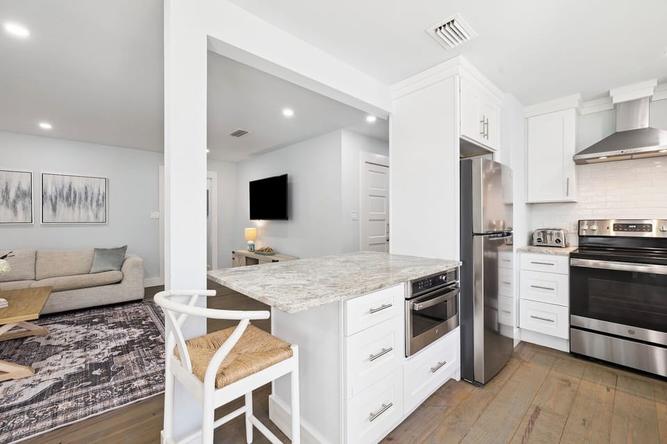 Cook your favorite meals in this bright, modern kitchen with granite counters, stainless appliances, and an open flow to your cozy living space.