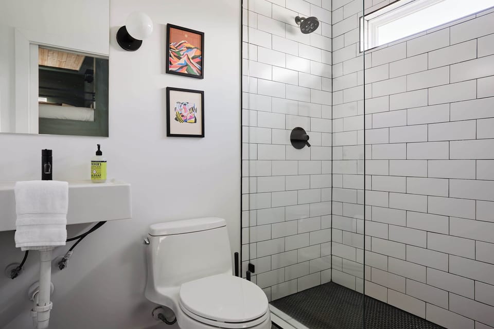 Don’t let its size fool you—this petite bathroom is perfectly designed to maximize space, offering everything you need in a stylish, compact layout.