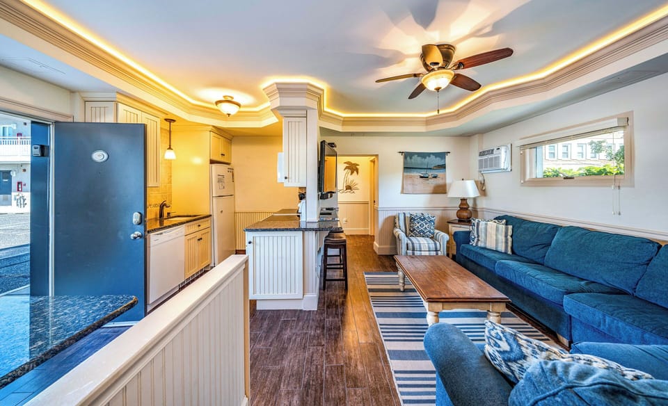 View of the kitchen area, kitchen island and living room

