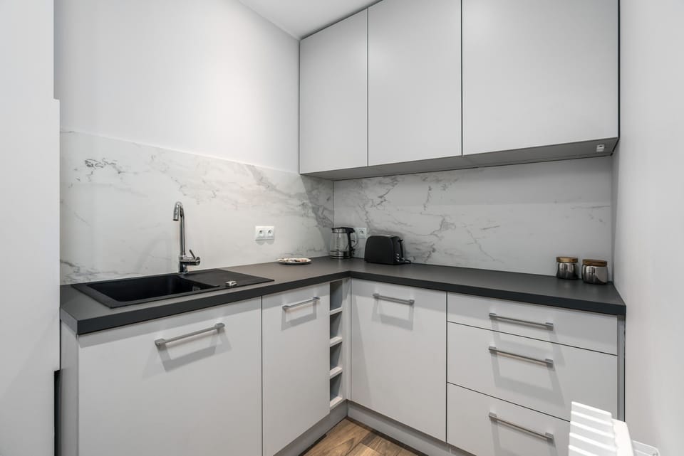 Another angle of the kitchen emphasizing its efficient design, with appliances and storage options.
