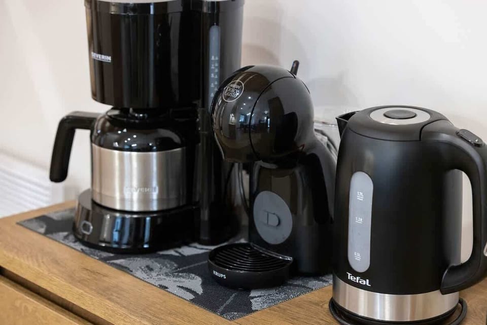 Fully equipped kitchenette with electric kettle and coffee maker.