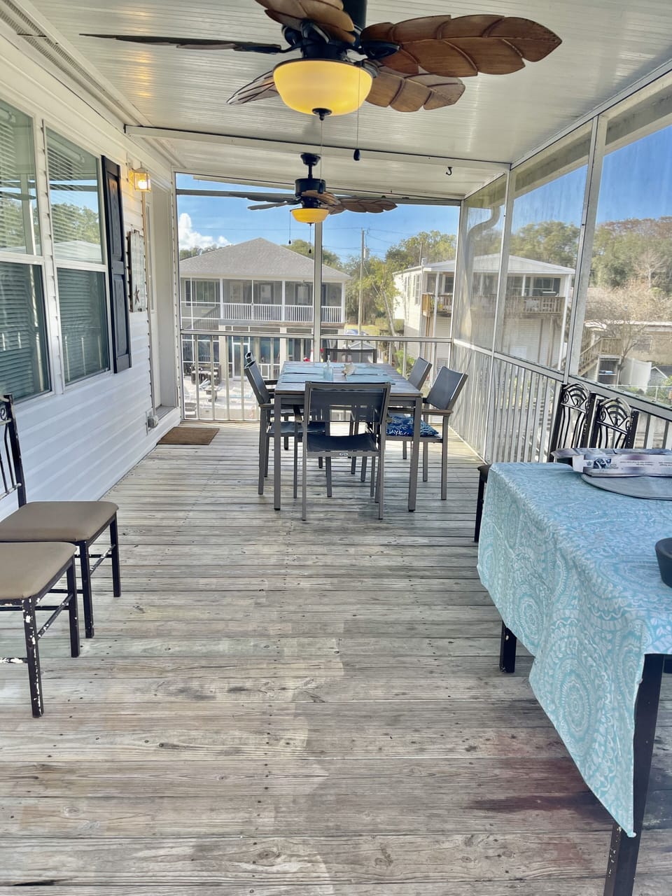 Screened balcony with caring fans, 2 tables, & chairs  over looking the water