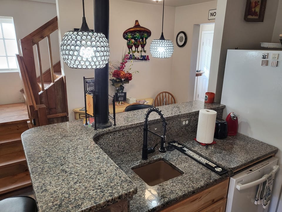 Wet bar counter in Kitchen with third sink/garbage disposal next to dishwasher.