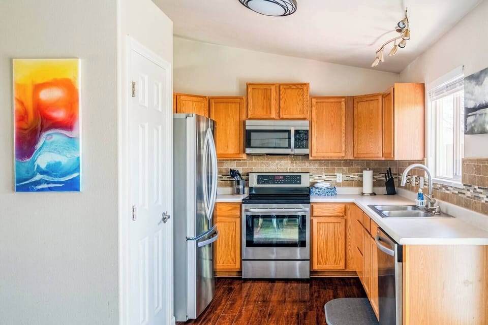 The kitchen is fully stocked, and the pantry has plenty of space to store food.