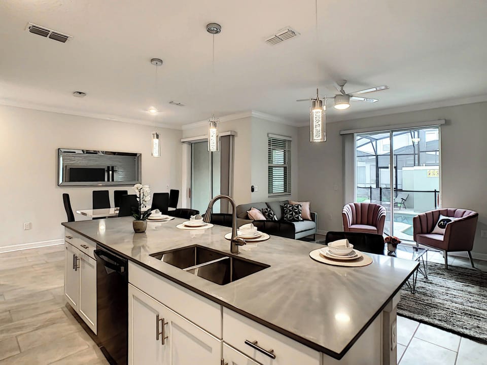 Modern Kitchen Island Overlooking Open Living and Dining