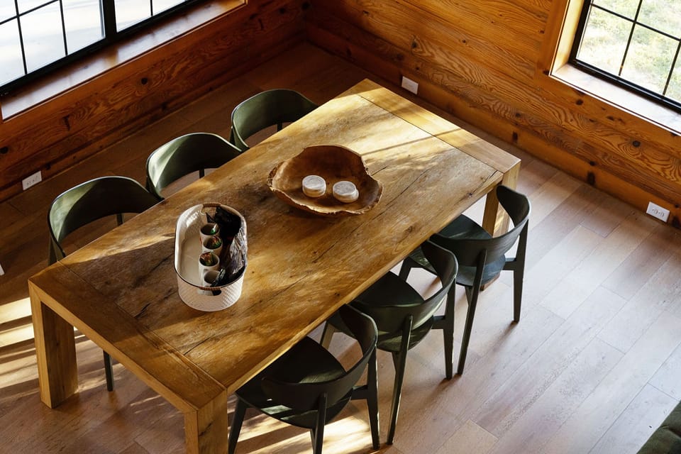 Rustic indoor dining table seats up to eight, perfect for shared meals, wine nights, and celebrations in Fredericksburg, TX.