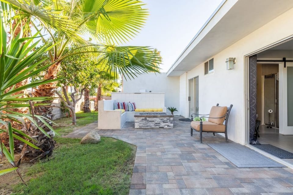 Lush landscaping surround multiple patio areas