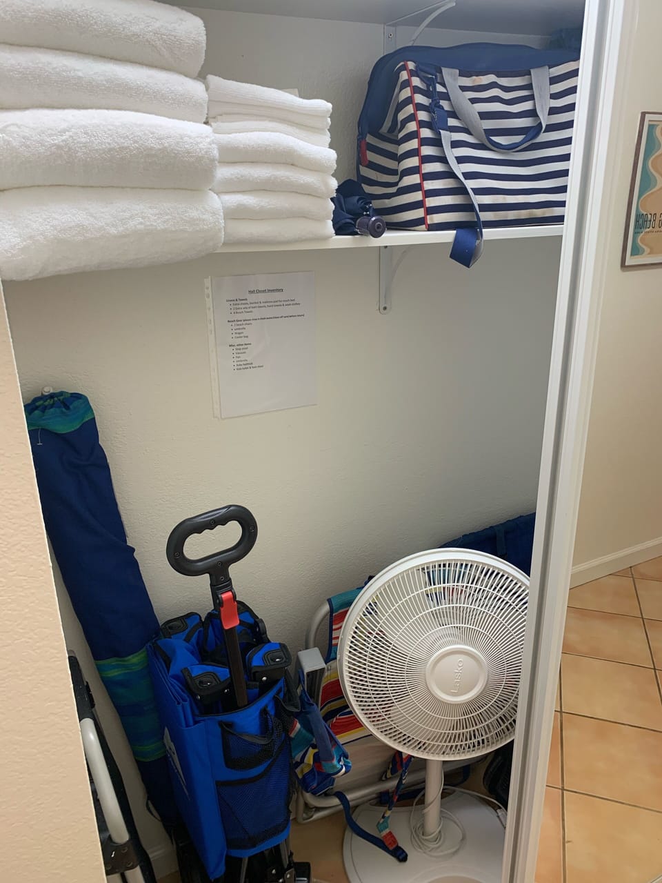 Beach gear including chairs, umbrella, beach wagon, cooler in hall closet
