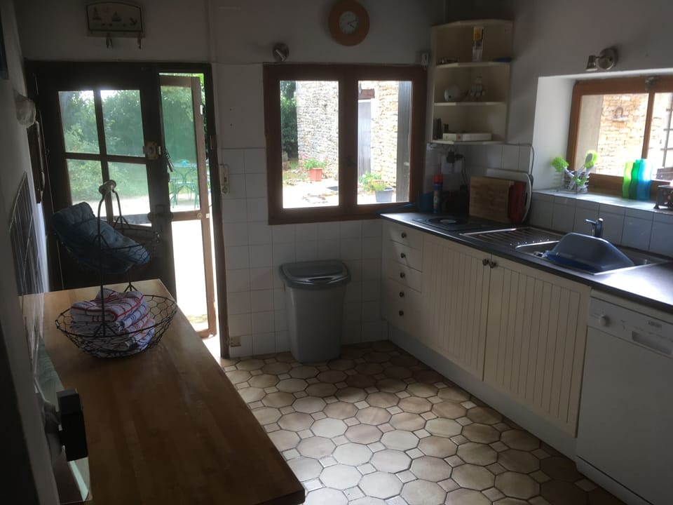 Kitchen. Looking out towards shared eating area and small house