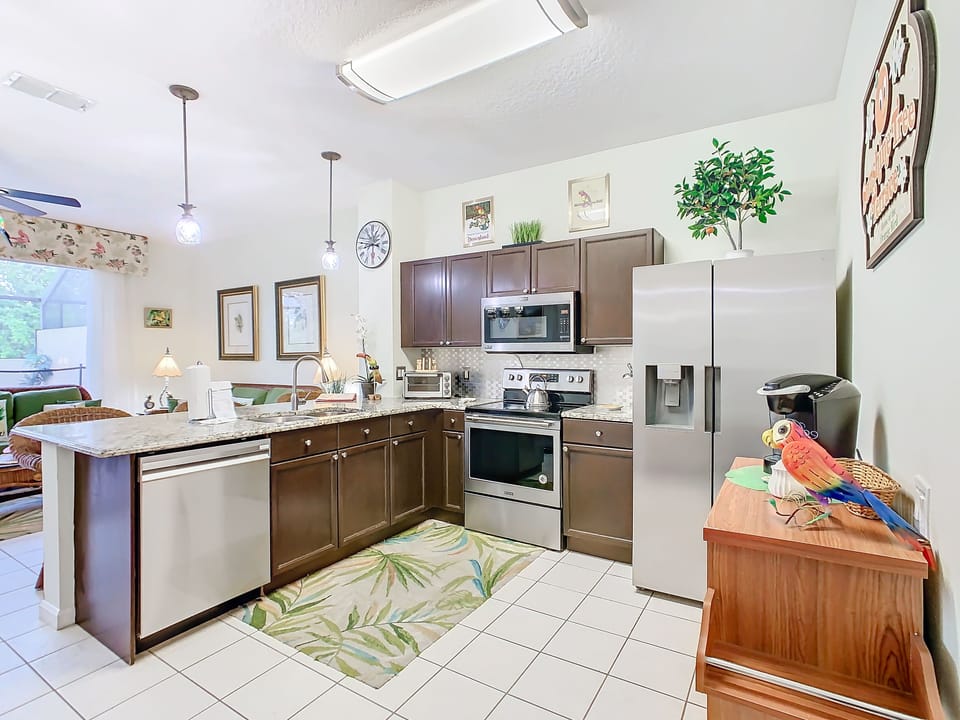 Fully equipped modern kitchen with stainless steel appliances and ample counter space.
