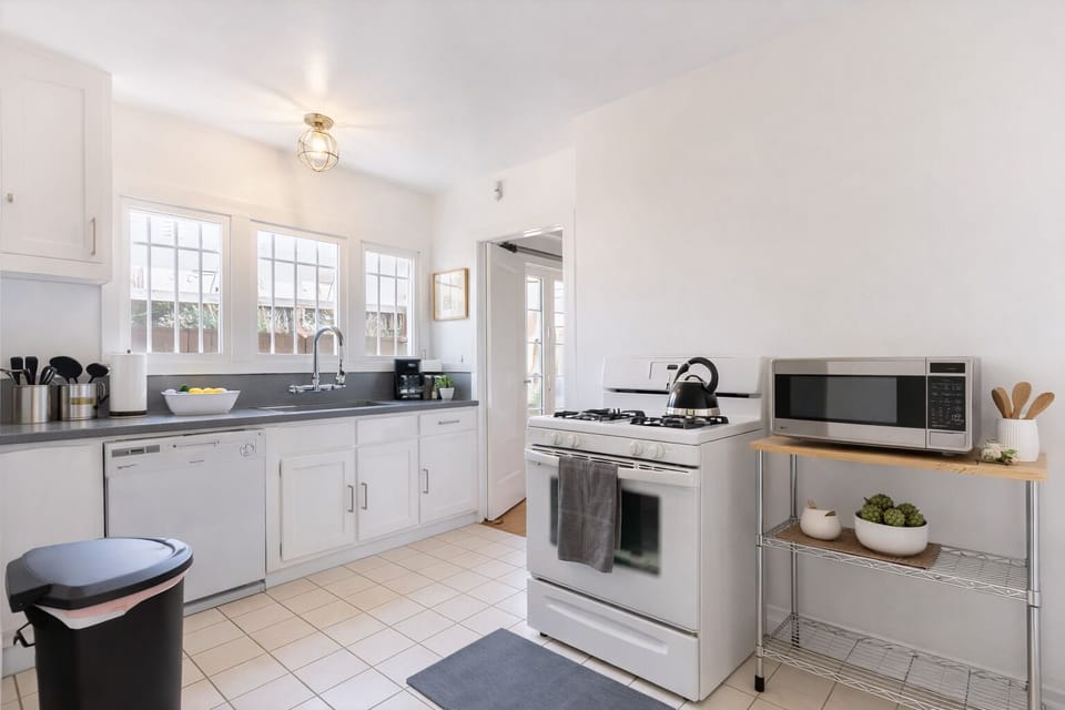 Fully equipped kitchen with modern appliances, ample counter space, and everything needed for home-cooked meals
