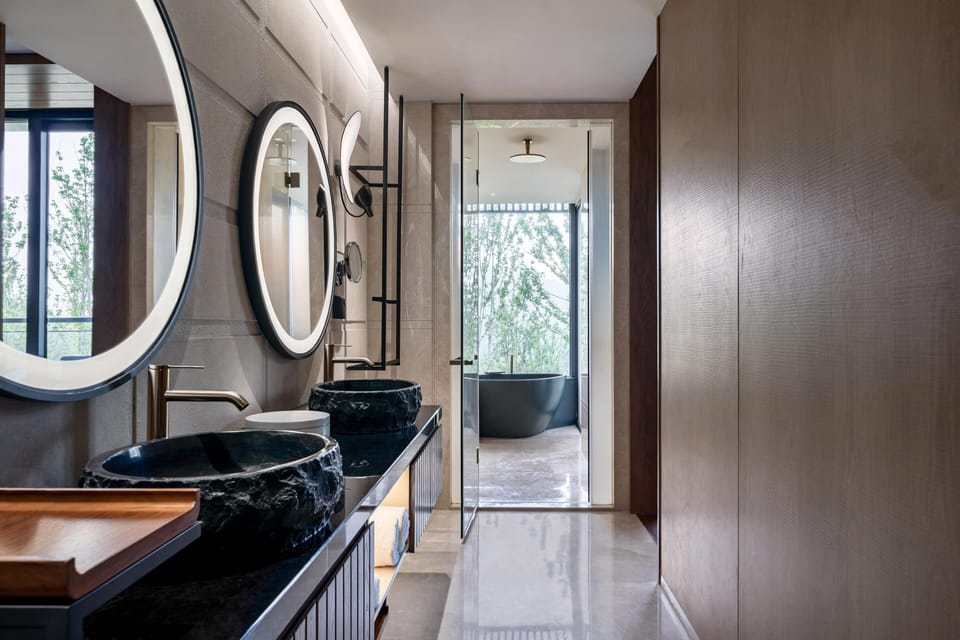 Suite, 1 King Bed, Garden View | Bathroom | Rainfall showerhead, slippers, towels
