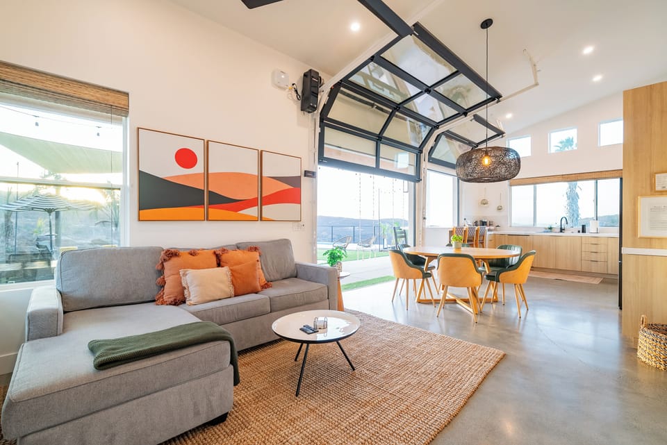 An open concept design connects the living room, dining room, and kitchen.