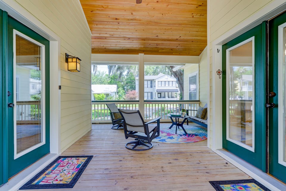 The screen-in porch has entrances to the main house and the studio suite.