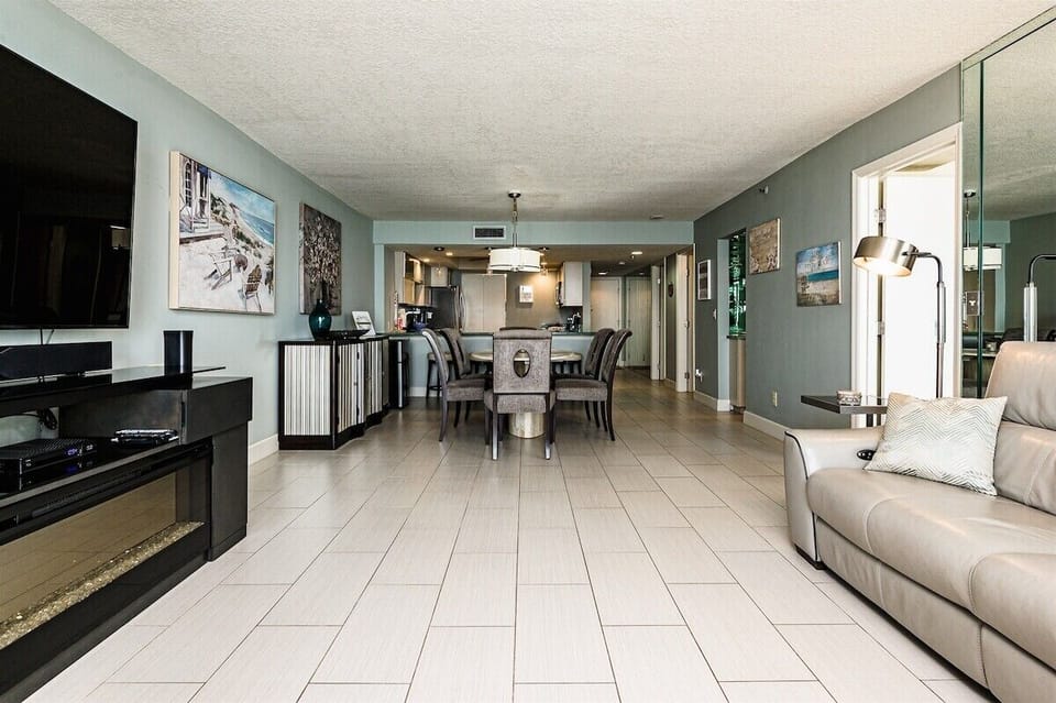 A look from the spacious living room into the dining area and kitchen