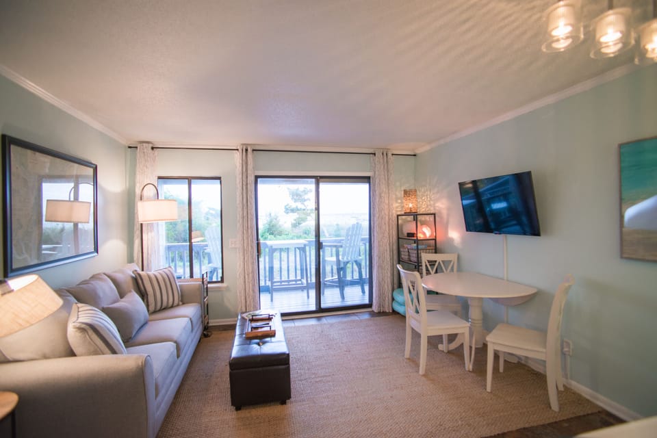 Living area with view of balcony and ocean front