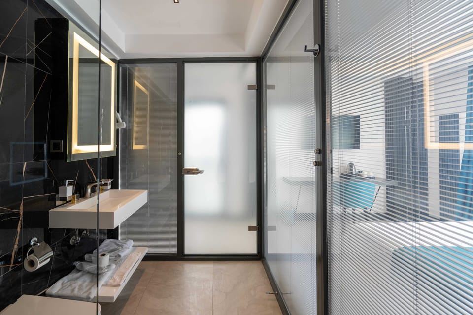 Shower, rainfall showerhead, designer toiletries, hair dryer
