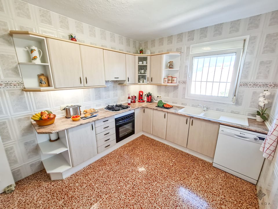 Kitchen with coffee machine, oven, washing machine and microwave