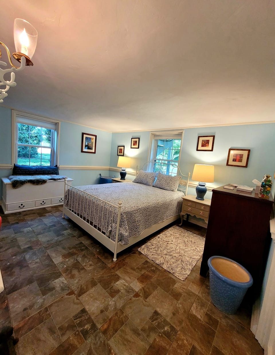 Large bedroom with sitting area. Full size iron and ironing board in closet.