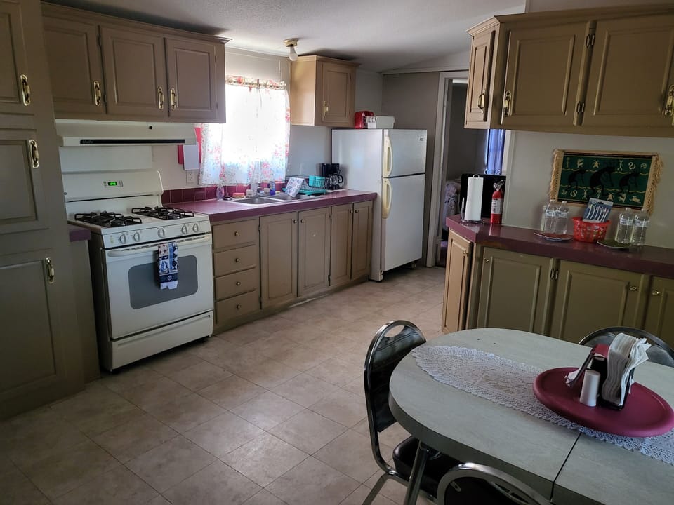 Full kitchen with gas stove and plenty of dishes and cookware.  