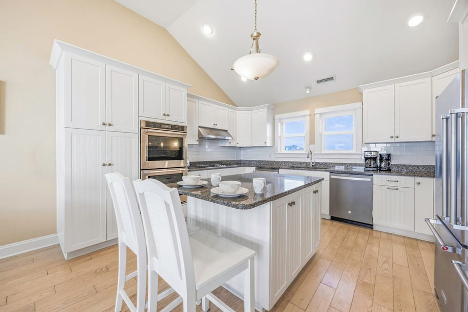 Your gourmet kitchen awaits with granite countertops, stainless steel appliances, and a center island perfect for morning coffee or preparing memorable meals together.