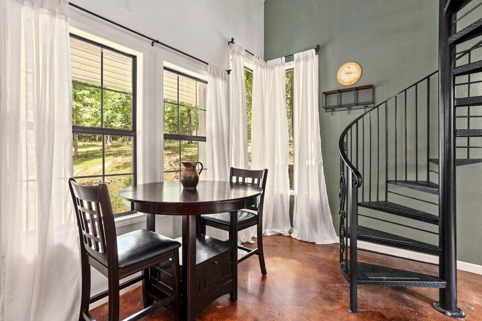 Enjoy dinner with a view! Large windows open up to lush trees on our secluded property!