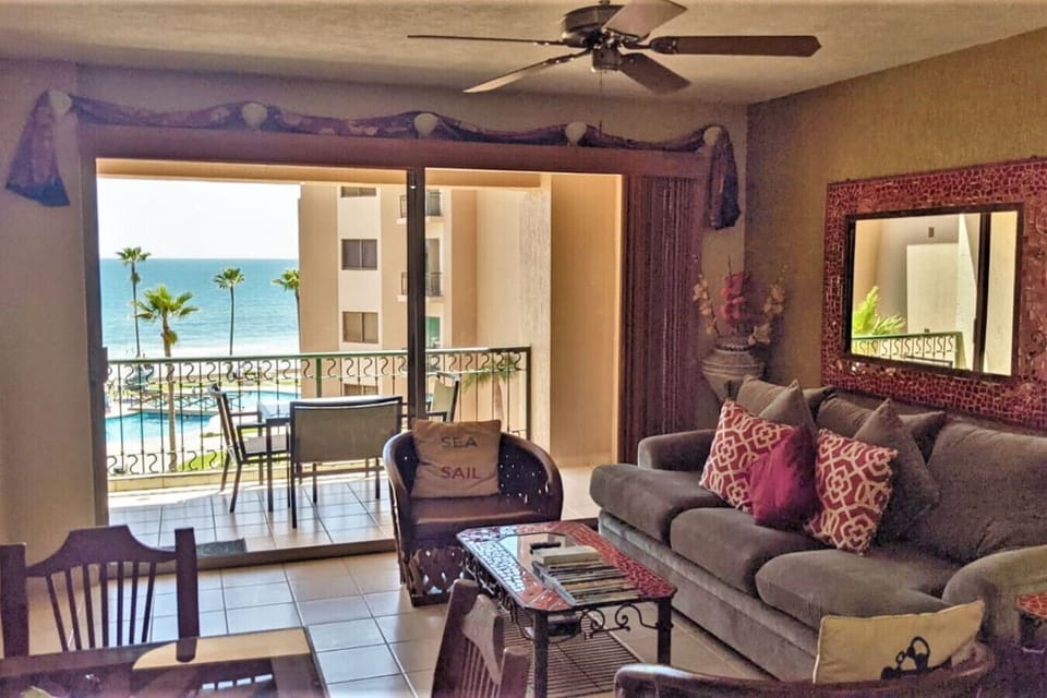 Living room with ocean and pool view.