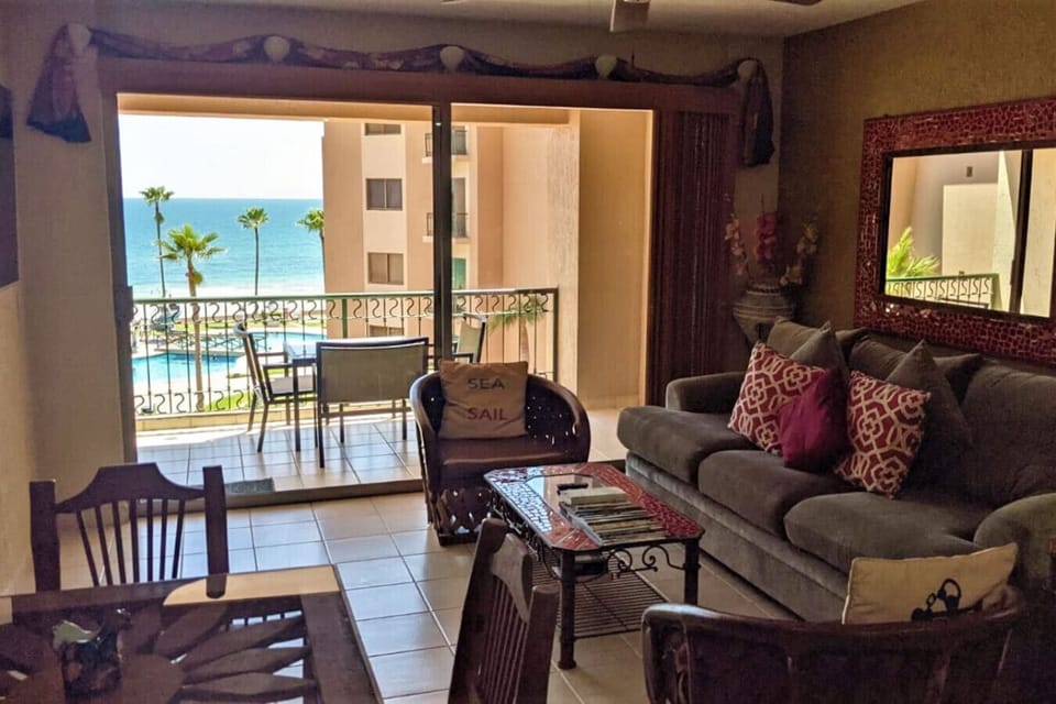 Living room with ocean and pool view.