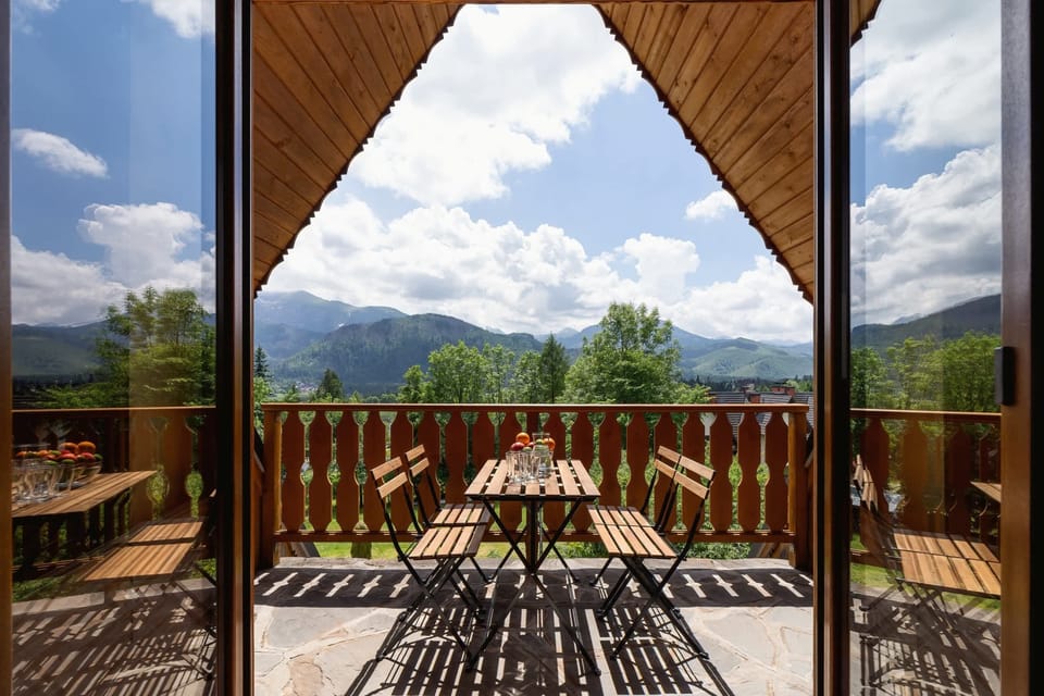 Another view from the balcony, showcasing the seating area and breathtaking scenery, perfect for relaxation.