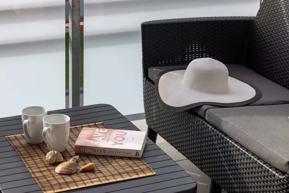 A close-up view of the balcony table and coffee mugs.