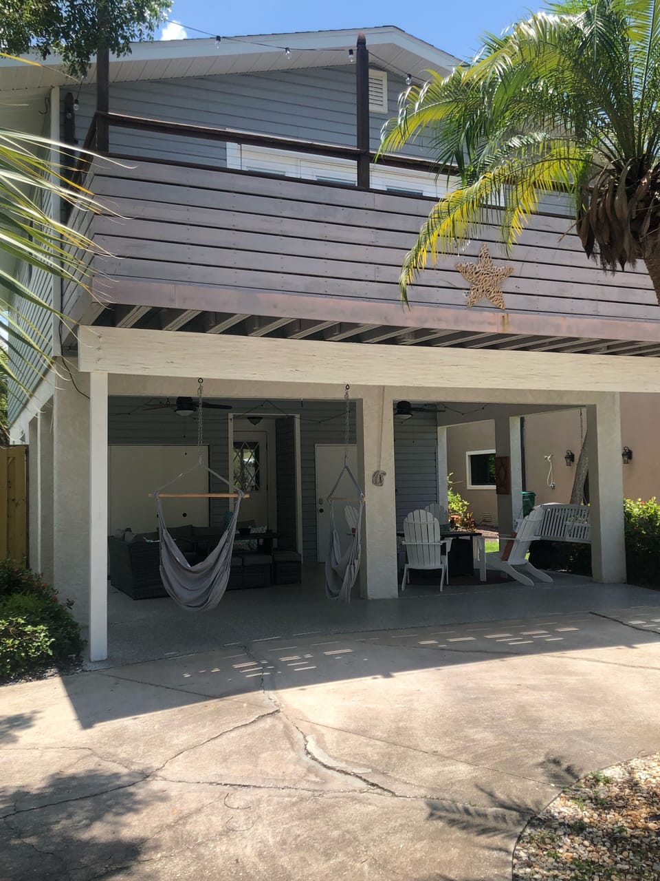 Front of the house with lots of seating under the lanai to enjoy the outdoors 