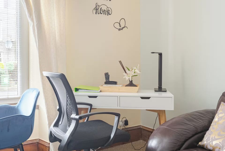 Stylish Workspace: This inviting desk area is equipped with a sleek, modern desk and comfortable ergonomic chair, ideal for staying productive or planning your adventures