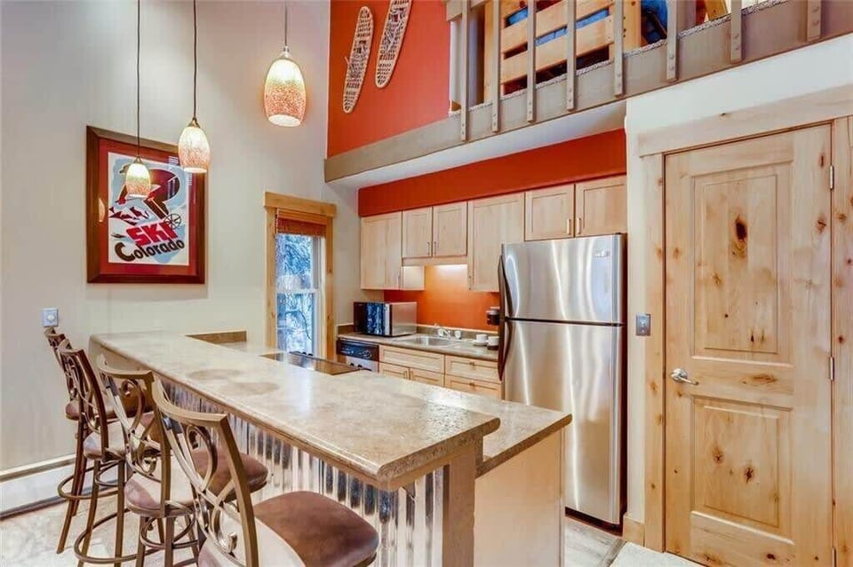 Fully-stocked kitchen with four bar stools