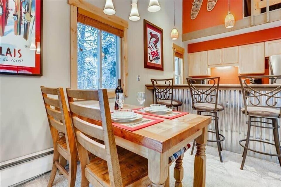 View of dining table with seating for 4 and kitchen