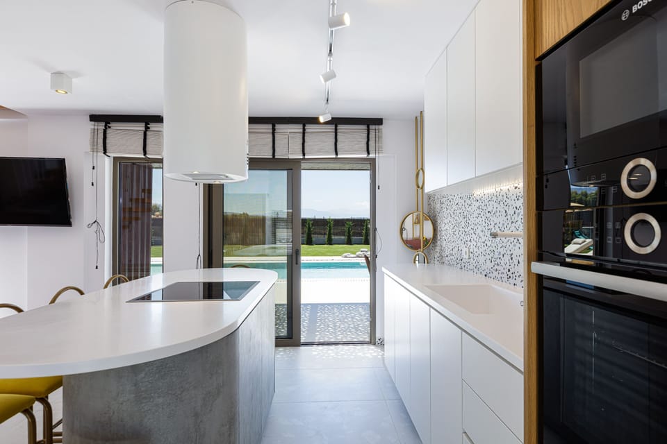 Kitchen has branded appliances and island to cook as a family