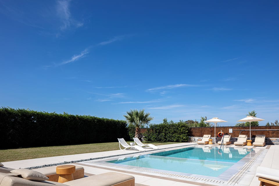 Enjoy a spacious pool with modern sunbeds and a beautifully landscaped setting, perfect for outdoor relaxation and entertaining
