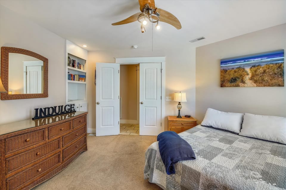 Your peaceful retreat awaits with a plush bed, coastal artwork, and warm lighting to help you unwind after a day of adventure.