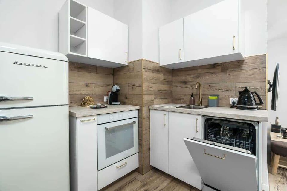 Another perspective of the kitchen, showcasing its efficient use of space and stylish finishes.