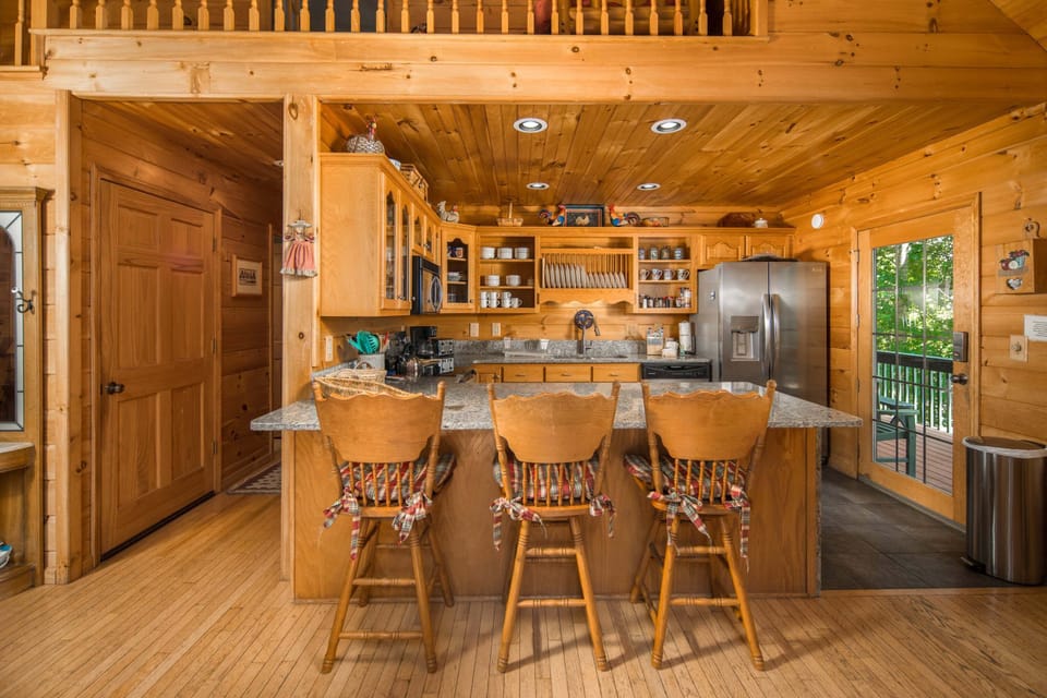 Gather in the open kitchen with island seating and easy access to the deck