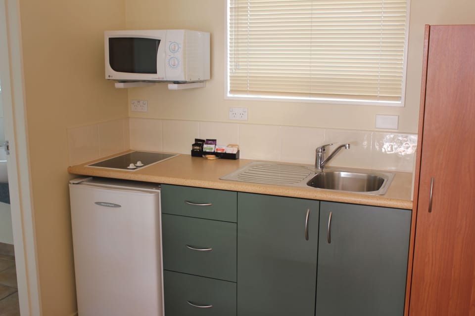 Fridge, microwave, coffee/tea maker, cookware/dishes/utensils