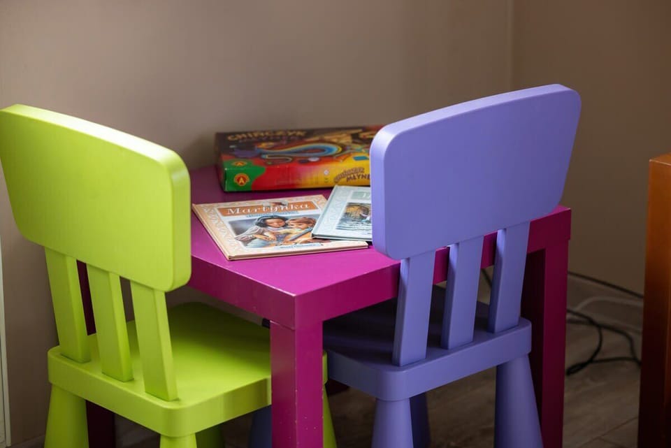 A children's corner in the living room with colorful chairs and a small table, adding a family-friendly touch.