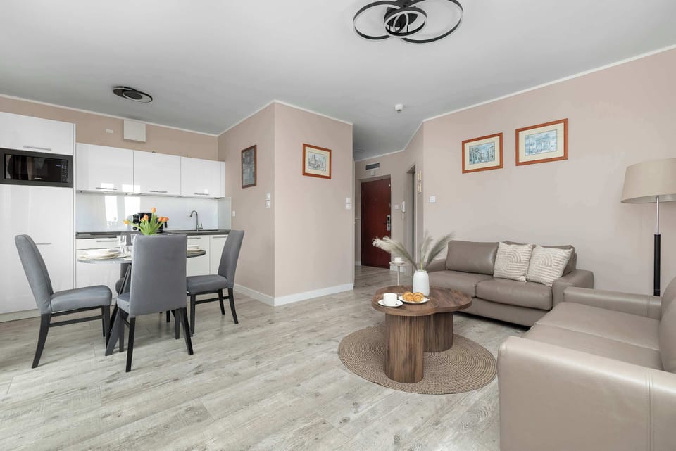 A living and dining space combined, featuring a table with chairs and a seating area.