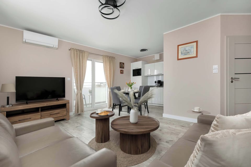 A stylish lounge setup with a sofa, armchair, and decorative elements in warm tones.