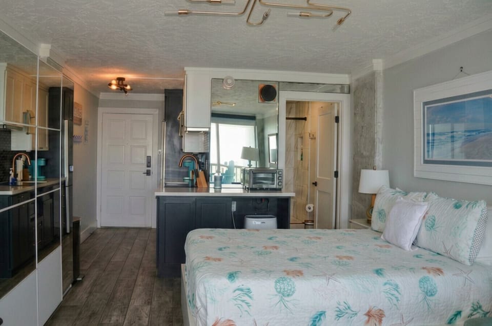 A view of the condo from the sliding glass door looking toward entry door on the left and bathroom door on right