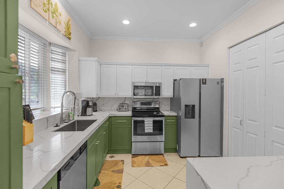 Fully equipped kitchen with modern appliances and granite countertops.