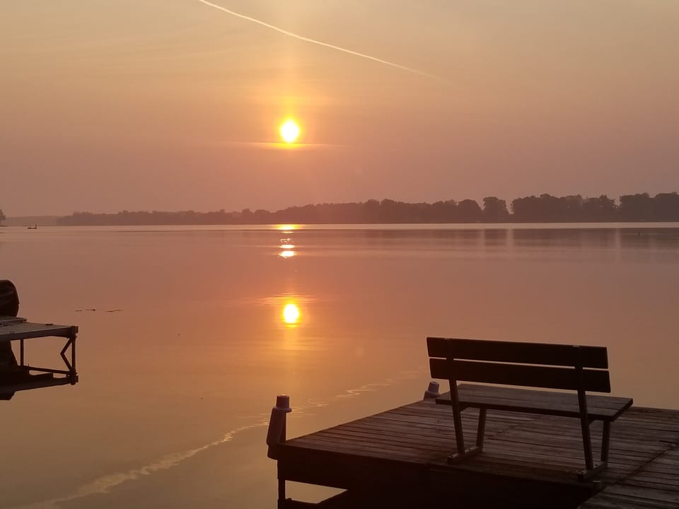 View of the sunrise off our pier with a bench on which to relax with AM coffee