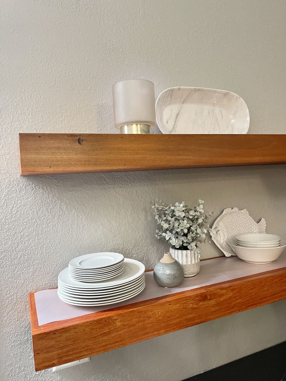 Open wall shelving to enhance the spaciousness of the room